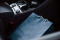 Blue bag lying in car. Close up view of interior of brand new modern luxury automobile Royalty Free Stock Photo