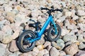 The blue balance bike on a rocky surface