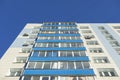 Blue balconies. High-rise building in city. Facade of house. Apartment house. Urban development