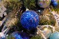 Blue ball hanging on a branch.