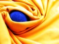 Blue ball of iron in yellow blanket. Royalty Free Stock Photo