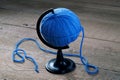 Blue ball of yarn on a stand for the Globe