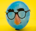 Blue Ballon with funny mask Royalty Free Stock Photo