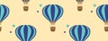 Seamless pattern with blue aerostats on a yellow background. Hot air balloons in the style of flat. gift wrap, print, textile, bac Royalty Free Stock Photo