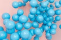 Blue balloons, blue bubbles on pink background. Modern punchy pastel colors. Dream fantasy concept