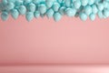 Blue balloons floating in pink pastel background room studio.
