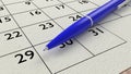 Blue ballpen on a paper calendar closeup Royalty Free Stock Photo