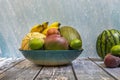 Blue bamboo tray with fresh seasonal fruits. Piel de sapo melons, mangoes and ripe bananas, peaches Royalty Free Stock Photo