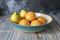 Blue bamboo wooden fruit bowl with Valencian oranges and lemons Royalty Free Stock Photo