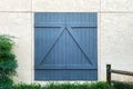 Blue barn door white stone building