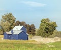 blue barn and storage with sand pile Royalty Free Stock Photo