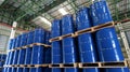 Blue barrel 200 liter chemical drums are stacked on wooden pallets inside the warehouse awaiting delivery. Concept of Chemical