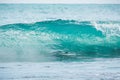 Blue barrel wave in tropical ocean. Wave crashing and sun light. Clear water.