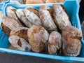 A blue basket filled with lots of different types of bread Royalty Free Stock Photo