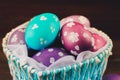Blue Basket in the form of heart with Easter eggs. Brown wooden Royalty Free Stock Photo
