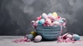 A Blue basket with blue and pink easter eggs and flowers isolated on grey background Royalty Free Stock Photo