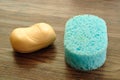 A blue bath sponge and a bar of soap