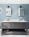 A blue bathroom with a grey cabinet and black and white tile floor. Royalty Free Stock Photo