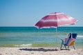 Blue beach chair bag and outdoor umbrella by the sea blue sky wave summer Royalty Free Stock Photo