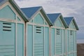 Blue beach sheds on the sand in a winter day Italy, Europe Royalty Free Stock Photo