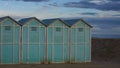 Blue beach sheds on the sand in a winter day Italy, Europe Royalty Free Stock Photo