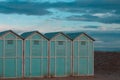 Blue beach sheds on the sand in a winter day Italy, Europe Royalty Free Stock Photo