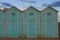 Blue beach sheds on the sand in a winter day Italy, Europe Royalty Free Stock Photo