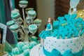 A blue beach themed doll cake . birthday cake for girls . Pastry chef decorates . Top view of homemade gingerbread like girl dolls