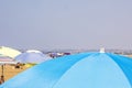 blue beach umbrella next to other umbrellas Royalty Free Stock Photo