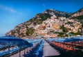 Blue beach umbrellas, chairs, deck chairs. Places to relax by the sea. The concept of quarantine and the beginning of the tourist Royalty Free Stock Photo