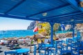 Blue beachside restaurant seating Kamari beach Santorini Greece