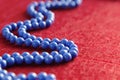 Blue beads on a red background Royalty Free Stock Photo