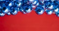 Blue Beads on a Red Background. Copy Space for Text. Macro Close-up. Background of Many Colored Beads Necklace Royalty Free Stock Photo