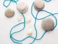 Blue beads on white stones, with drops of water Royalty Free Stock Photo