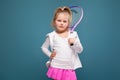 Adorable cute little girl in white shirt, white jacket and pink skirt with tennis racket Royalty Free Stock Photo