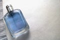 Blue beautiful glass transparent fashionable glamorous bottle of cologne, perfume and ribbon of sparkling rhinestones, diamonds an Royalty Free Stock Photo