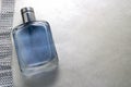 Blue beautiful glass transparent fashionable glamorous bottle of cologne, perfume and ribbon of sparkling rhinestones, diamonds an Royalty Free Stock Photo