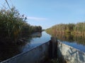 Blue beautiful river and wooden old boat blue sky green yellow grass natural background Russia Royalty Free Stock Photo