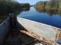 Blue beautiful river and wooden old boat blue sky green yellow grass natural background Russia Royalty Free Stock Photo