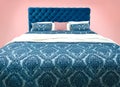 Blue bed furniture with patterned bed linen . Soft velour fabric bed. Classic modern furniture on isolated background