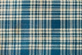 Blue and beige chequered fabric in a close up view