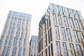 Blue beige modern apartment building. Tile and glass facade. View from street, view from below Royalty Free Stock Photo