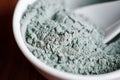 Blue bentonite clay powder in a bowl. Diy facial mask and body wrap recipe. Natural beauty treatment and spa. Clay texture closeup