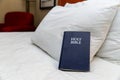Bible on bed in hotel room