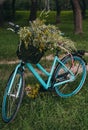 Blue bicycle with a basket of flowers