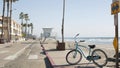 Bicycle cruiser bike by ocean beach, California coast USA. Summer cycle, lifeguard tower and palms.