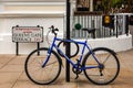 Blue bicycle locked to lantern column near the queens gate terrace in London