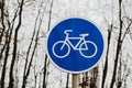 A blue bicycle sign sign signifying a bike path.
