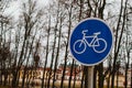 A blue bicycle sign sign signifying a bike path.