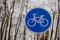 A blue bicycle sign sign signifying a bike path.